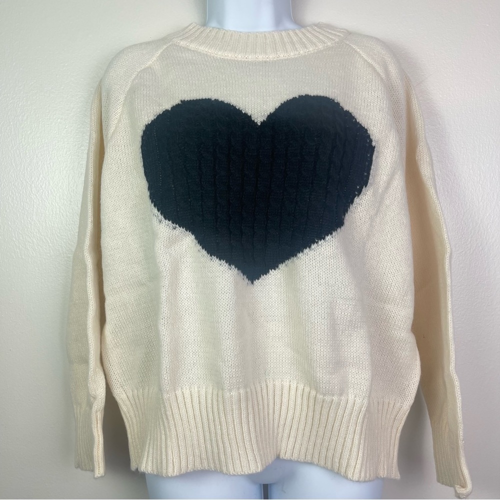 Cream crewneck pullover sweater with a cable knit black heart